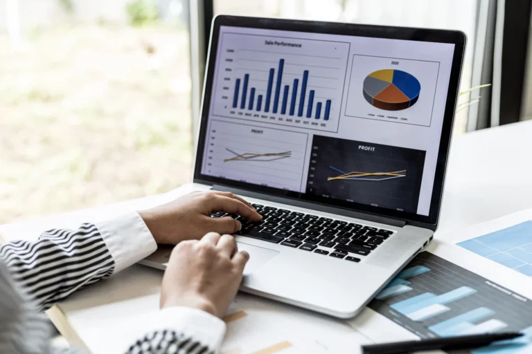 Laptop showing business performance charts and operational data