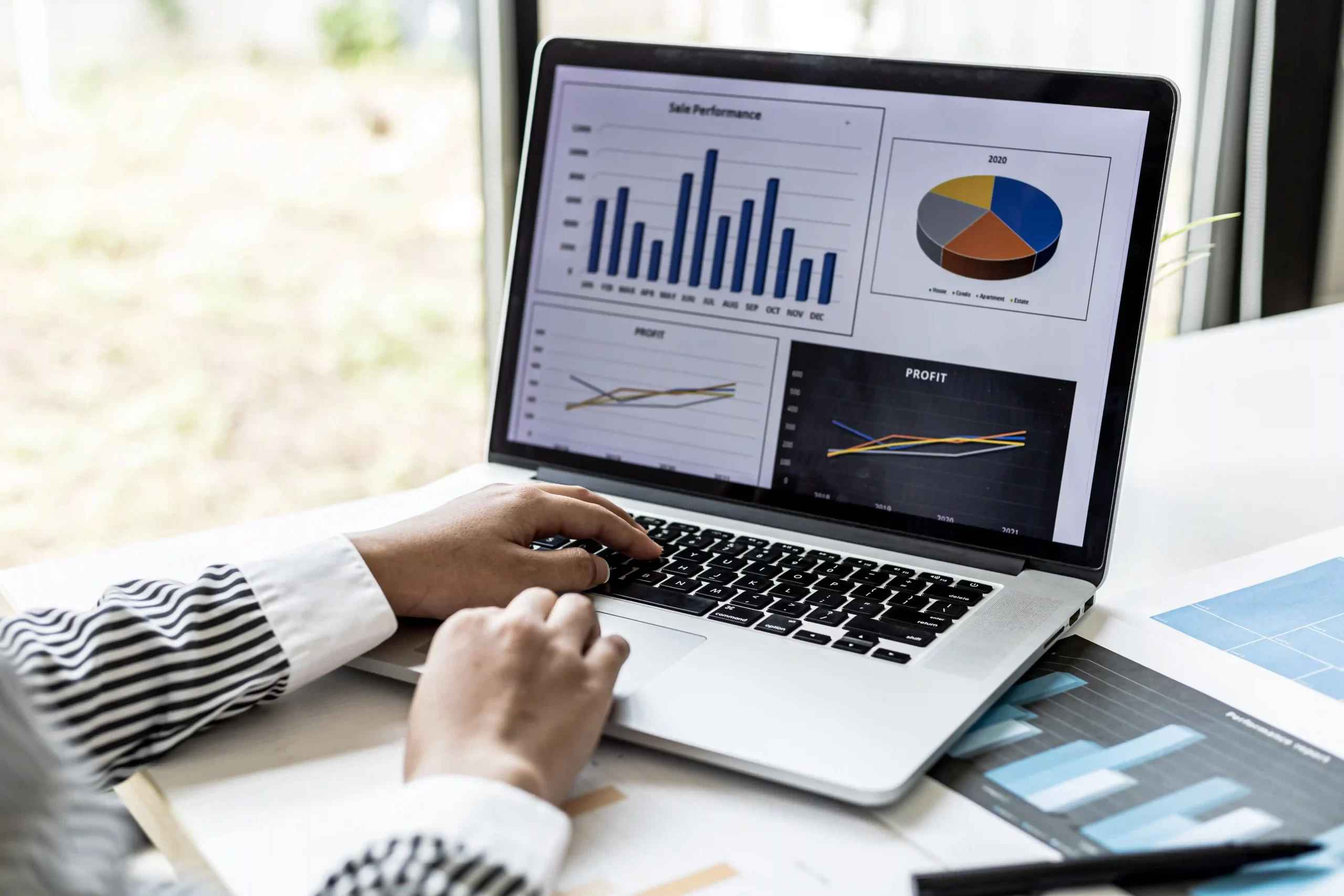 Laptop showing business performance charts and operational data